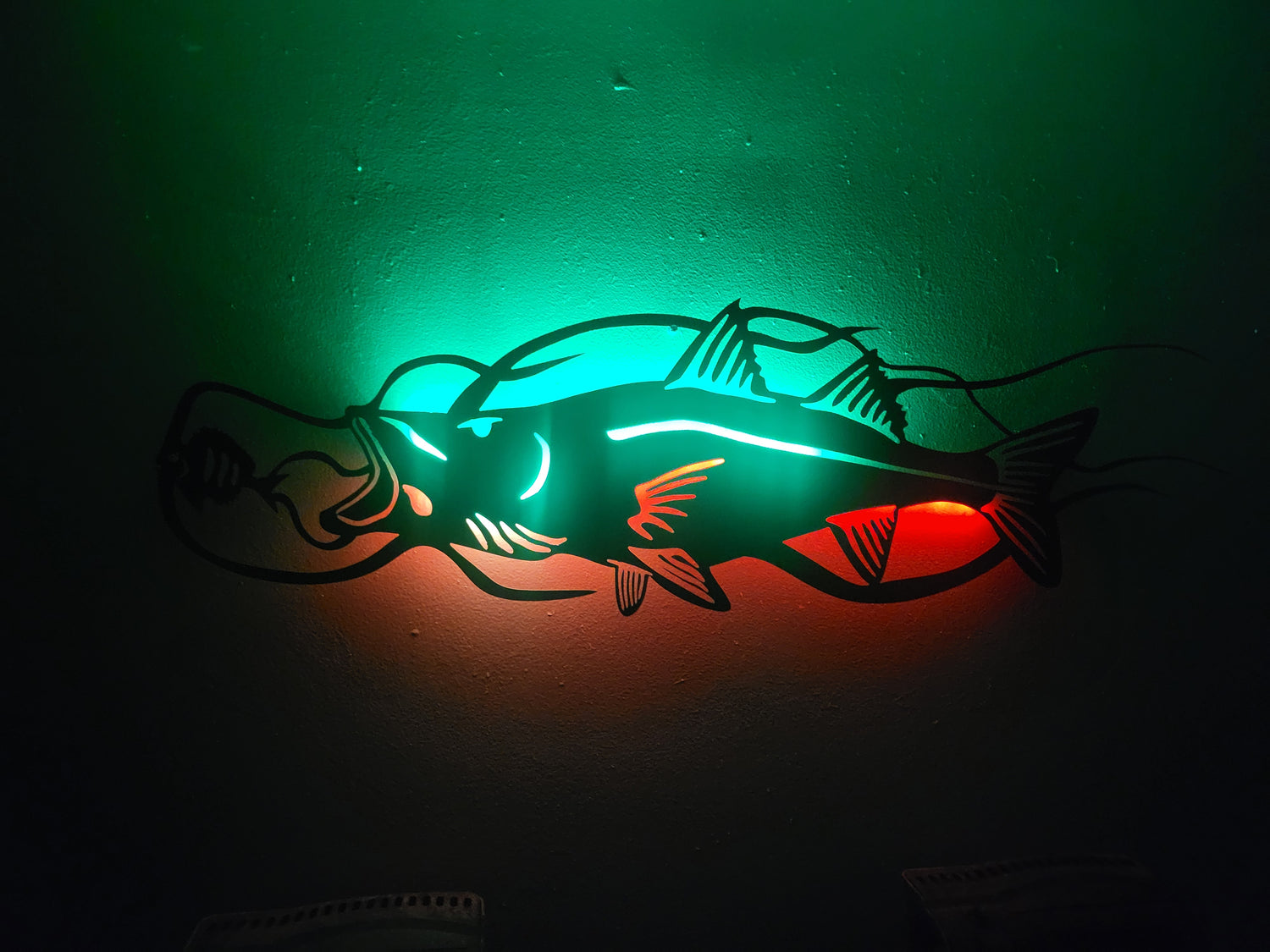 Fishing lure with glowing green and red light on a dark background